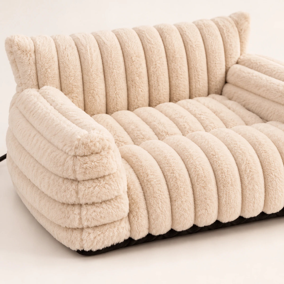 Close view of cream ribbed plush, padded back and side arm